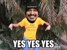 a man wearing a yellow shirt that says " yes yes yes " on it