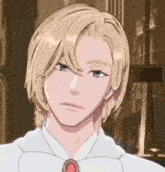 a man with blonde hair and a red necklace