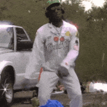 a man wearing a coca cola shirt is dancing in front of a white truck