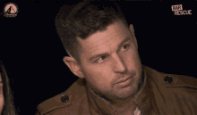 a man in a brown jacket is on a screen that says paramount network