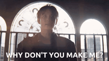 a man standing in front of a window with the words " why don 't you make me "