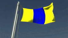 a yellow and blue flag is waving in the wind against a blue sky