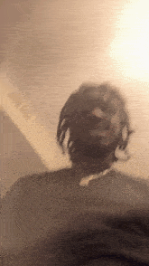 a blurry picture of a man wearing a black shirt