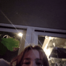 a woman 's face is visible in a blurry photo