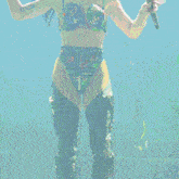 a woman is standing in front of a green screen