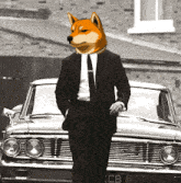 a man in a suit and tie with a dog 's head standing next to a car with a license plate that says cb
