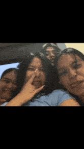 a group of girls are posing for a picture and one girl is making a funny face