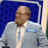 a man in a light blue suit has a name tag that says jack on it