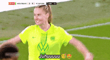 a female soccer player is wearing a yellow shirt with a vw logo on it .