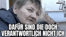 a woman is sitting in front of a sign that says dafür sind die doch verantwortlich nicht ich .
