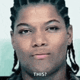 a man with dreadlocks is making a funny face and saying `` this '' .
