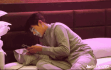a man with white paint on his face is laying on a bed with judleklek702 written below him