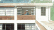 a couple kissing on a balcony in front of a building with the number 11 on it