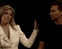 a man and a woman are looking at each other in a bar .