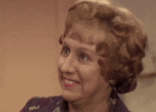 a close up of a woman making a funny face while smiling .