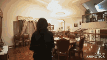 a woman stands in a large room with the words made in animotica on the bottom