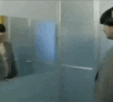 a blurry picture of two people standing next to each other .