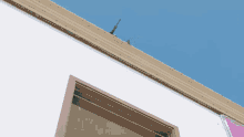 a white building with a window and a blue sky