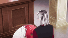 a woman with red hair is kneeling down next to a man with silver hair