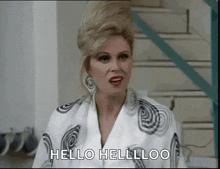 a woman is saying hello hellloo in front of stairs
