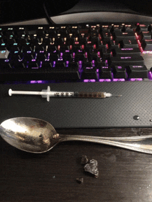 a spoon and a syringe on a keyboard that says ctrl on the bottom