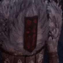 a close up of a person 's back with a red patch on it
