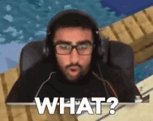 a man wearing headphones and glasses is sitting in a chair and asking what .