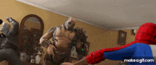 a cartoon of spider-man fighting a monster in a living room on make-a-gif.com