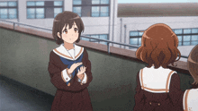 a girl in a school uniform has the letter k on the back of her shirt