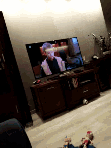 a flat screen tv with the letters tb on the bottom