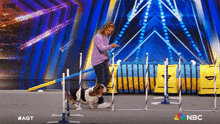 a woman and a basset hound on a stage with the nbc logo
