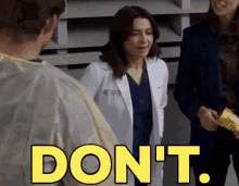 a woman in a lab coat says " do n't " while talking to a man