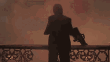a man in a suit is standing on a balcony with his arms wide open