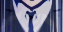 a man in a suit and tie is standing in a dark room .