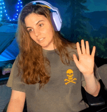 a woman wearing headphones and a shirt with a skull on it