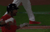 a baseball player wearing a red jersey that says guardians