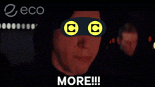 a man wearing a mask with the letter c on it is screaming with the word more below him
