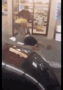 a blurred image of a person standing in front of a window in a store .