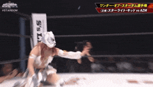 a woman in a wrestling ring with a sign that says ' sis ' on it