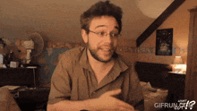a man wearing glasses and a brown shirt says what gifrun.com on the bottom right