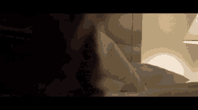 a person is laying on a bed with a lamp in the background