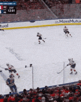 a group of hockey players are playing a game on a rink .