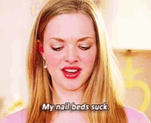 a woman says my nail beds suck in a pink shirt