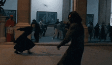 a group of people are standing in front of a building with a sign that says ' apocalypse '