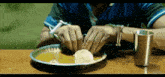 a man with handcuffs is sitting at a table eating food