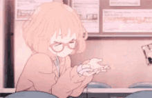 a girl wearing glasses is sitting at a table with a cup of coffee in her hand .