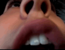 a close up of a person 's mouth with their teeth showing .