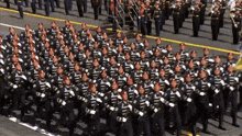 a large group of soldiers march in a parade