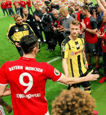 a soccer player in a red jersey with the number 9 on the back