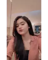 a woman in a pink shirt takes a selfie